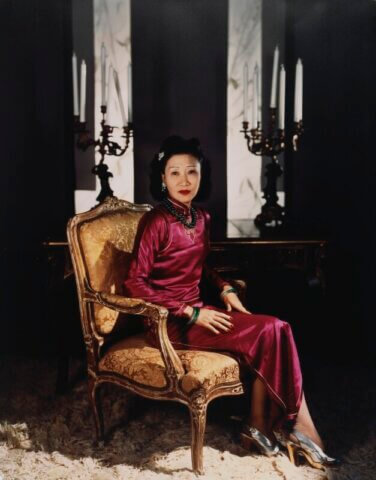 Madame Koo wearing a "body-hugging 1930's qipao" with a side slit